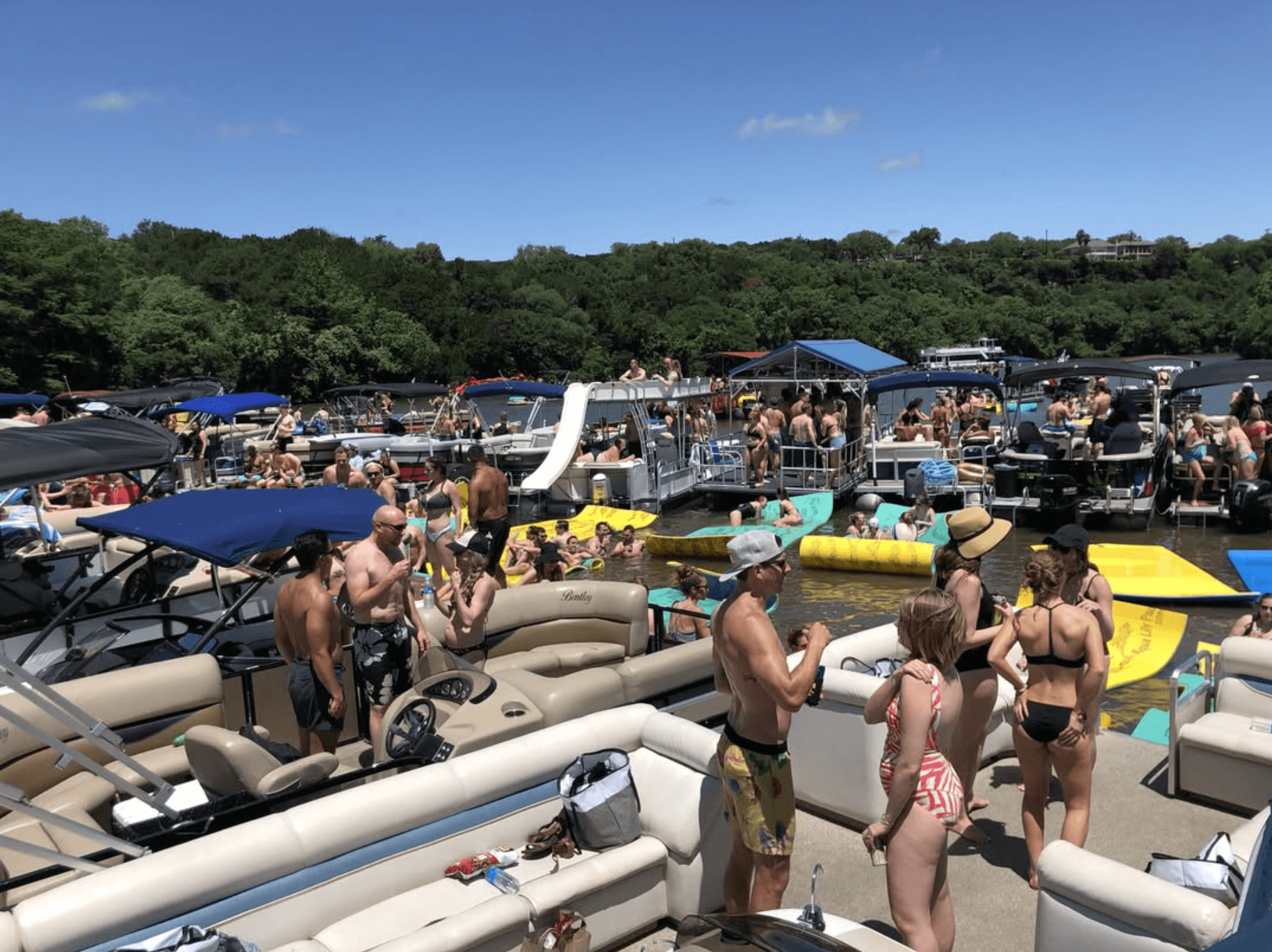 Party cove scene on Lake Travis with boats and floats