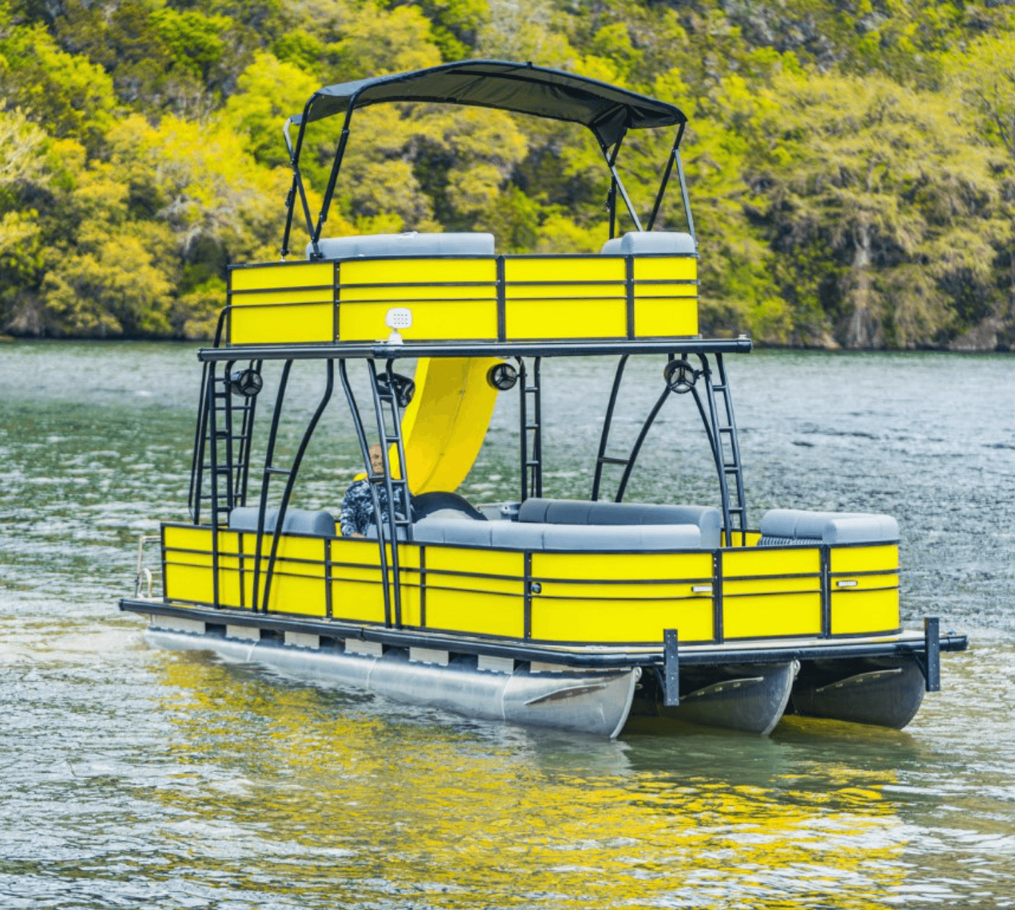 Double-decker yellow party barge with slide on Lake Travis