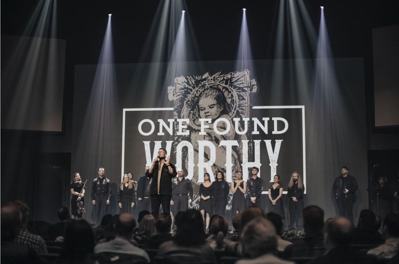 A One Found Worthy production with choir and dramatic lighting