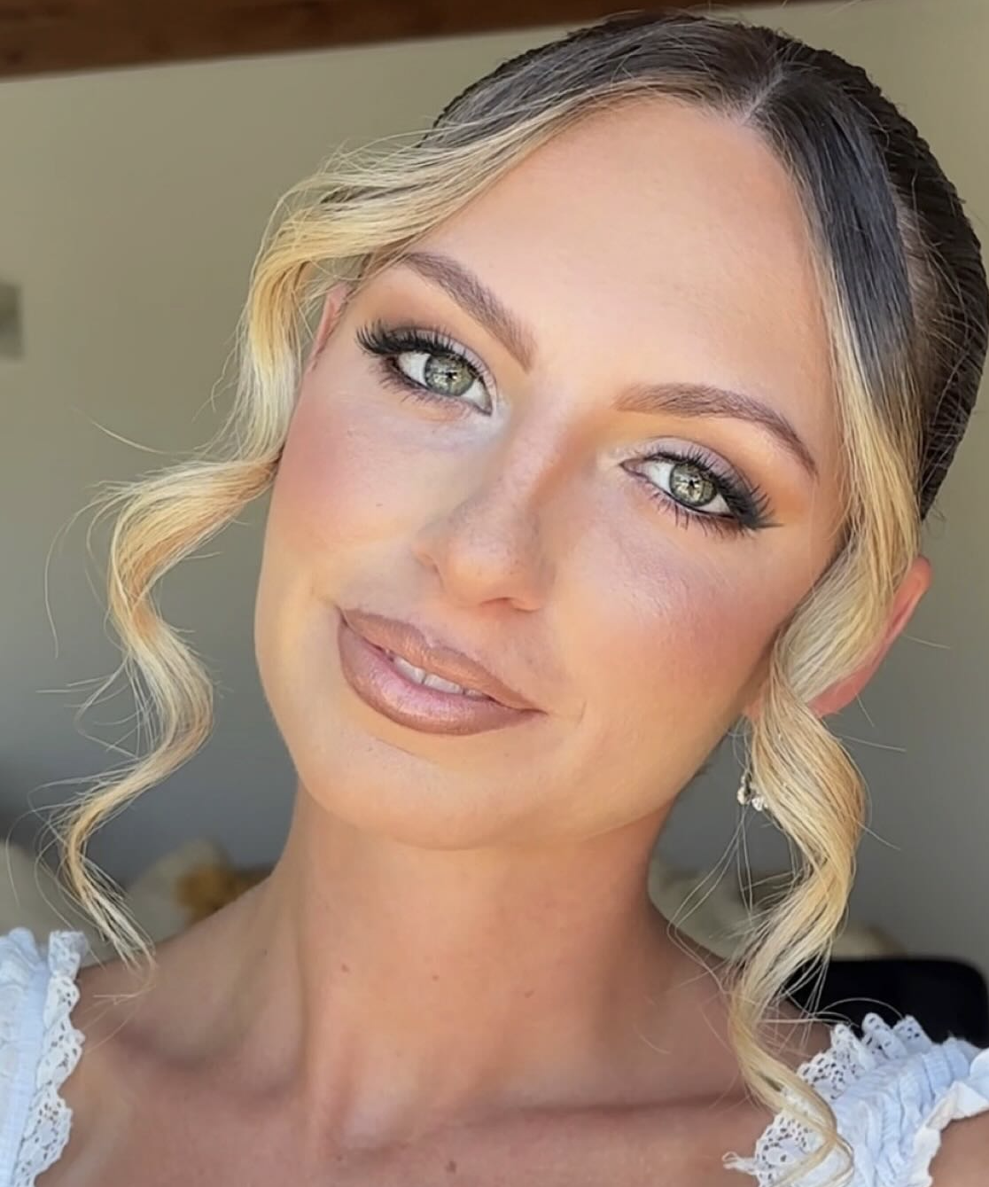 Blonde bride with soft bronzed glam, green eyes and soft curls