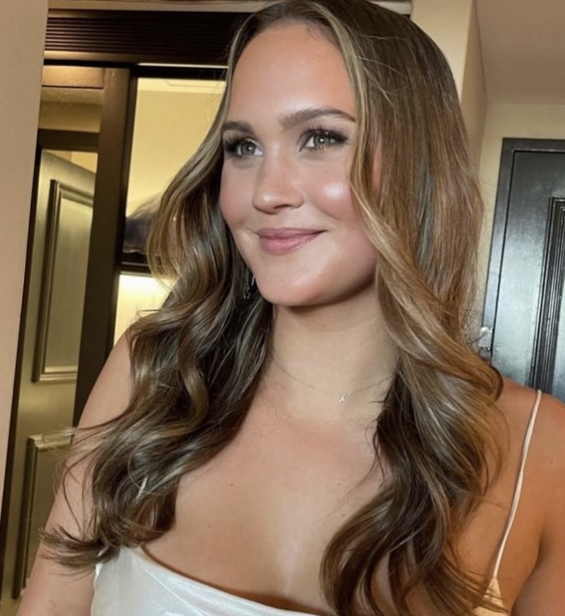 Client with balayage Hollywood waves and glowy soft glam