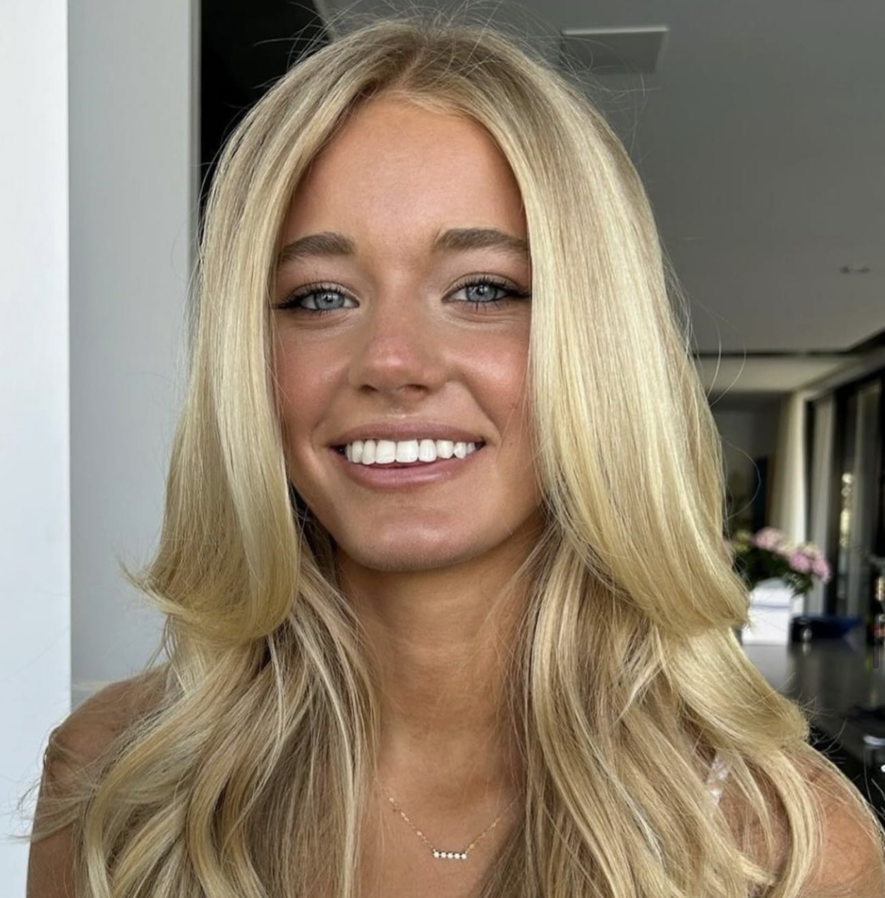 Blonde client with glowing natural glam and a voluminous blowout