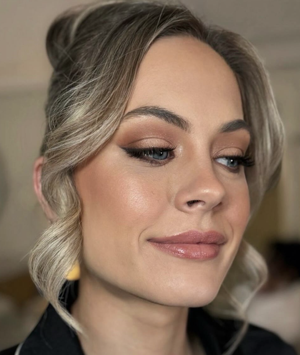 Client with bronzed glam and a soft textured updo