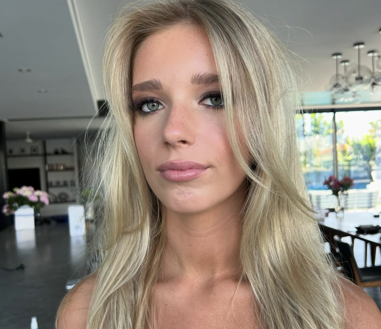 Blonde client with soft smokey eyes, nude lip and tousled hair