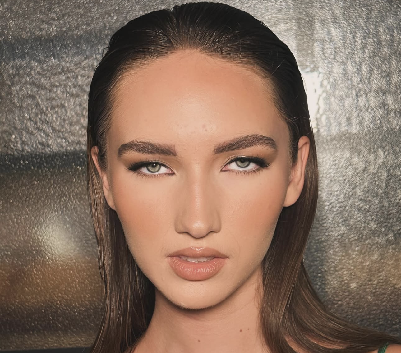Bronzed green-eyed glam with wet-look slicked hair
