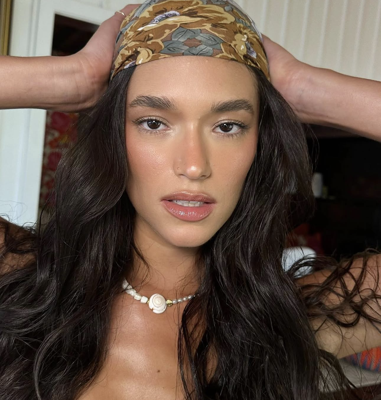 Beauty look with a floral headscarf and glowing natural makeup