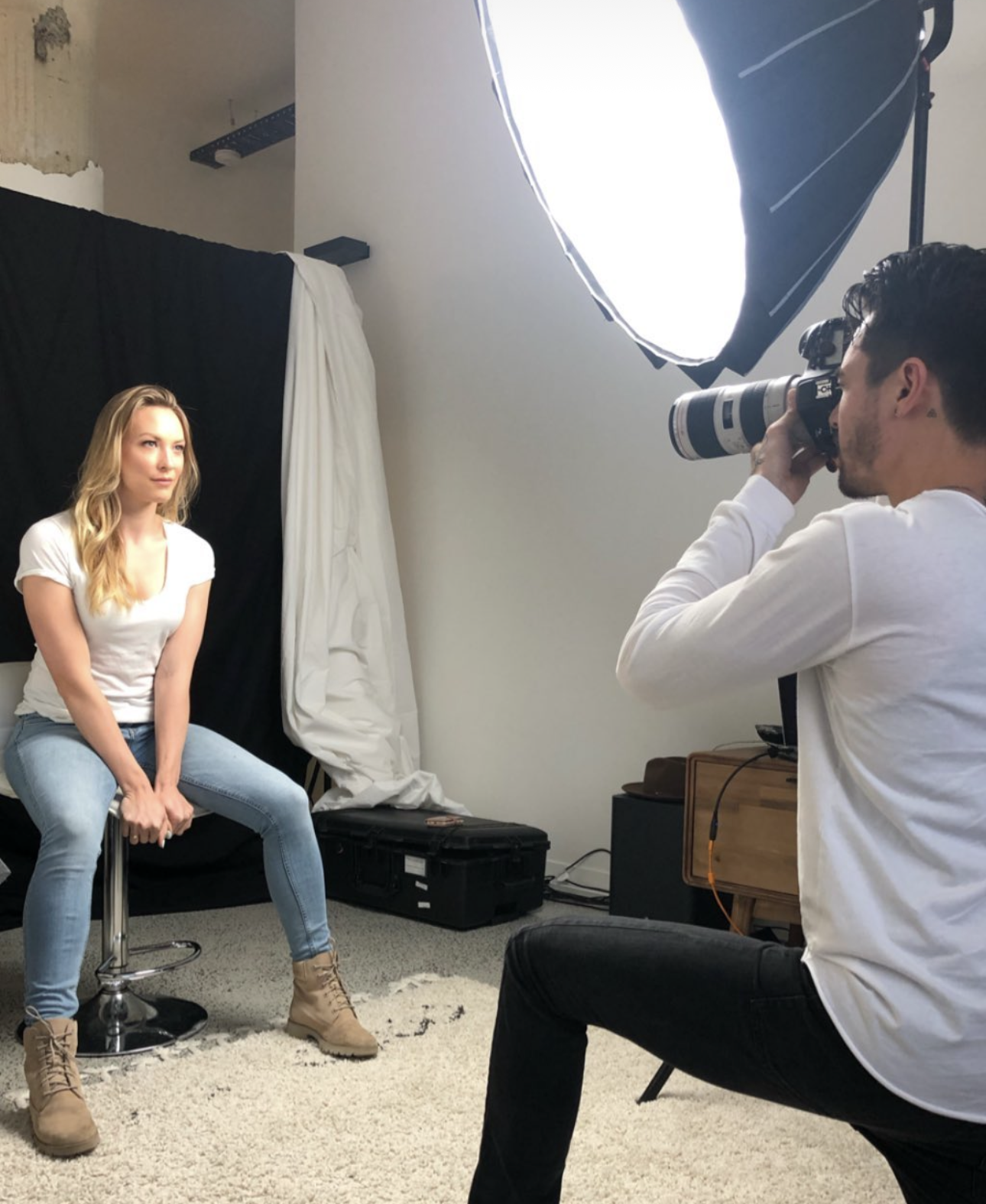 Photographer shooting a model on set under a softbox