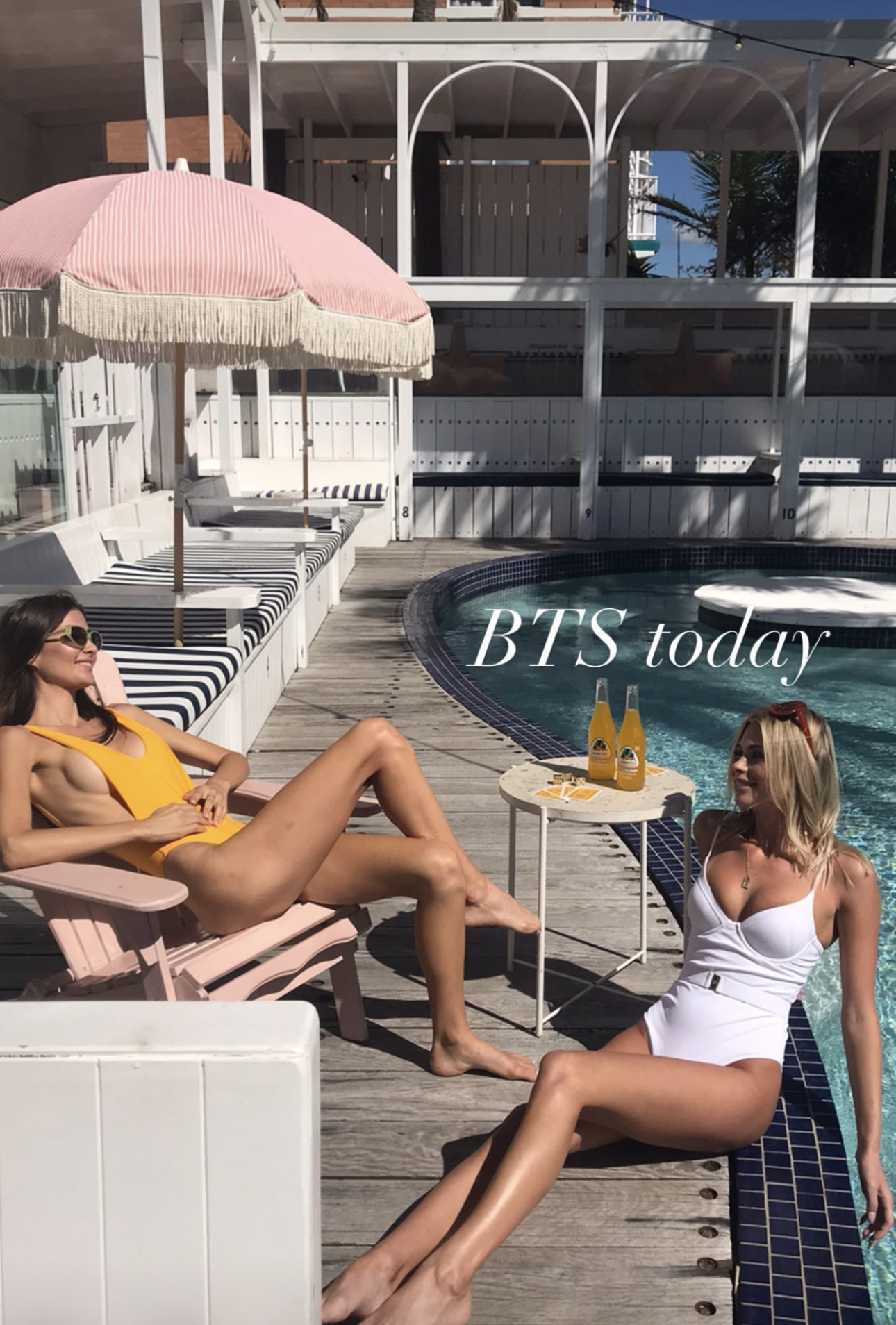 Behind the scenes of a poolside shoot with two models in swimwear