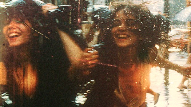 Friends laughing in reflective water