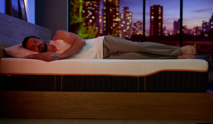 Person sleeping comfortably on an Emma mattress at night
