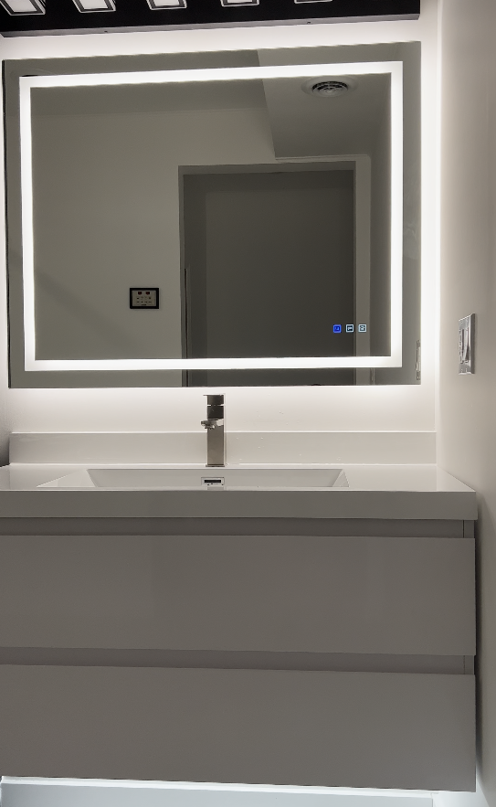Modern gray floating vanity with integrated white sink and large rectangular backlit LED mirror