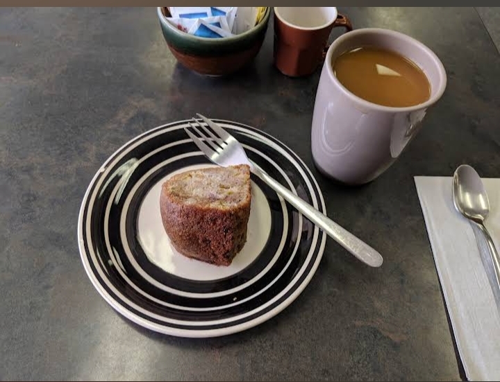 Tea and cake at a cafe table