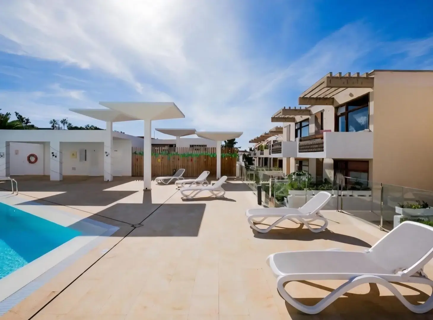 Resort pool with white loungers