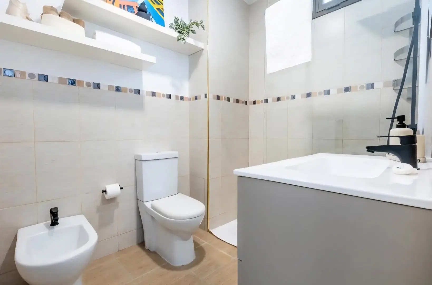 Bathroom with bidet, toilet and vanity