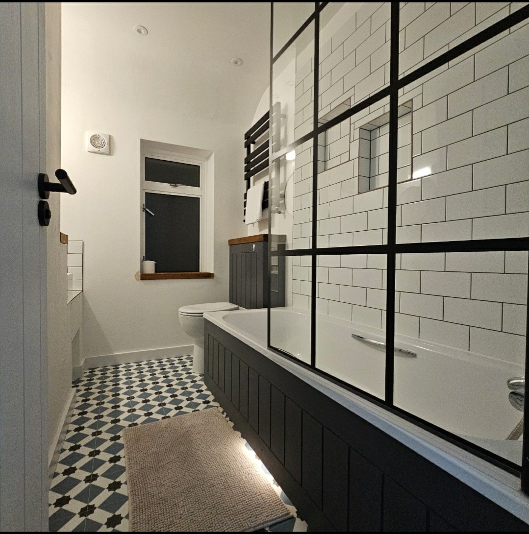 Bathroom after renovation - modern design with subway tiles and shower enclosure