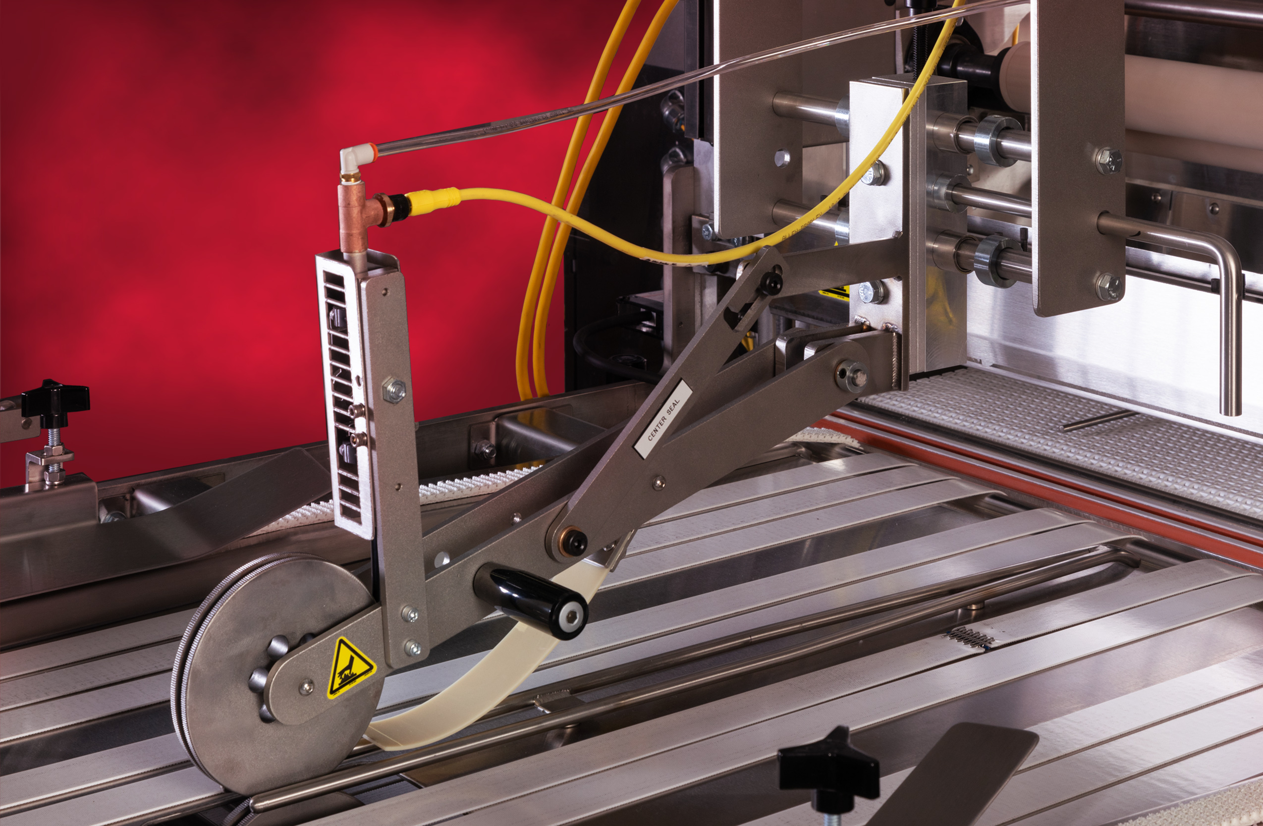 Seal and cut mechanism on a commercial bakery packaging line