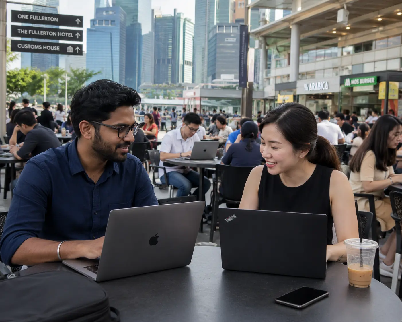 SgWebDesign team working at One Fullerton Singapore with CBD skyline in the background