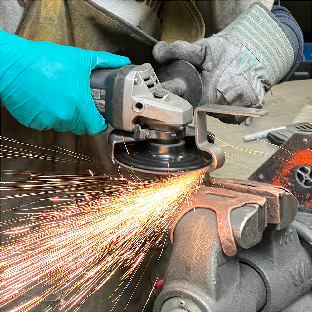 Highland Forge craftsperson fabricating metal hardware in the workshop
