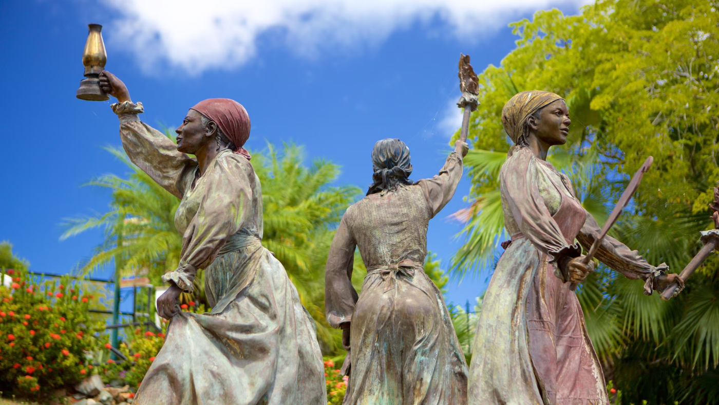 Three Queens statue in a garden setting