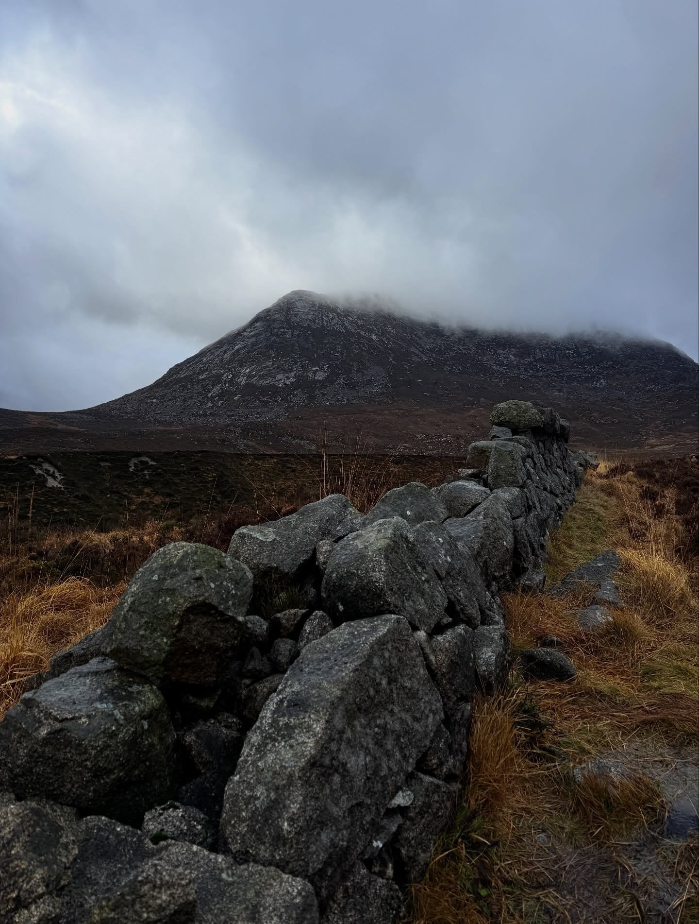 Misty Irish mountain with stone wall