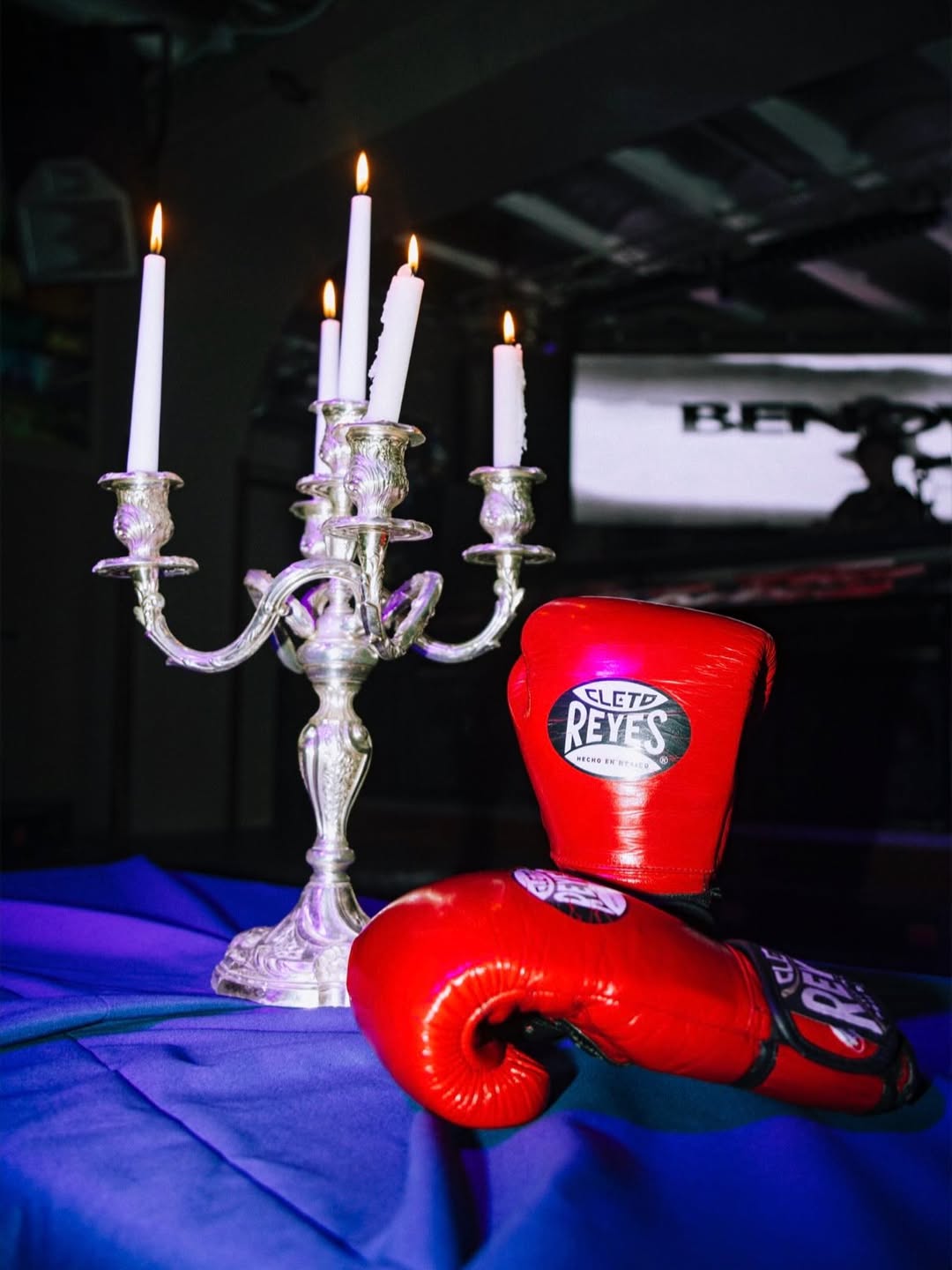 BENOW signature — Cleto Reyes boxing gloves beside a silver candelabra