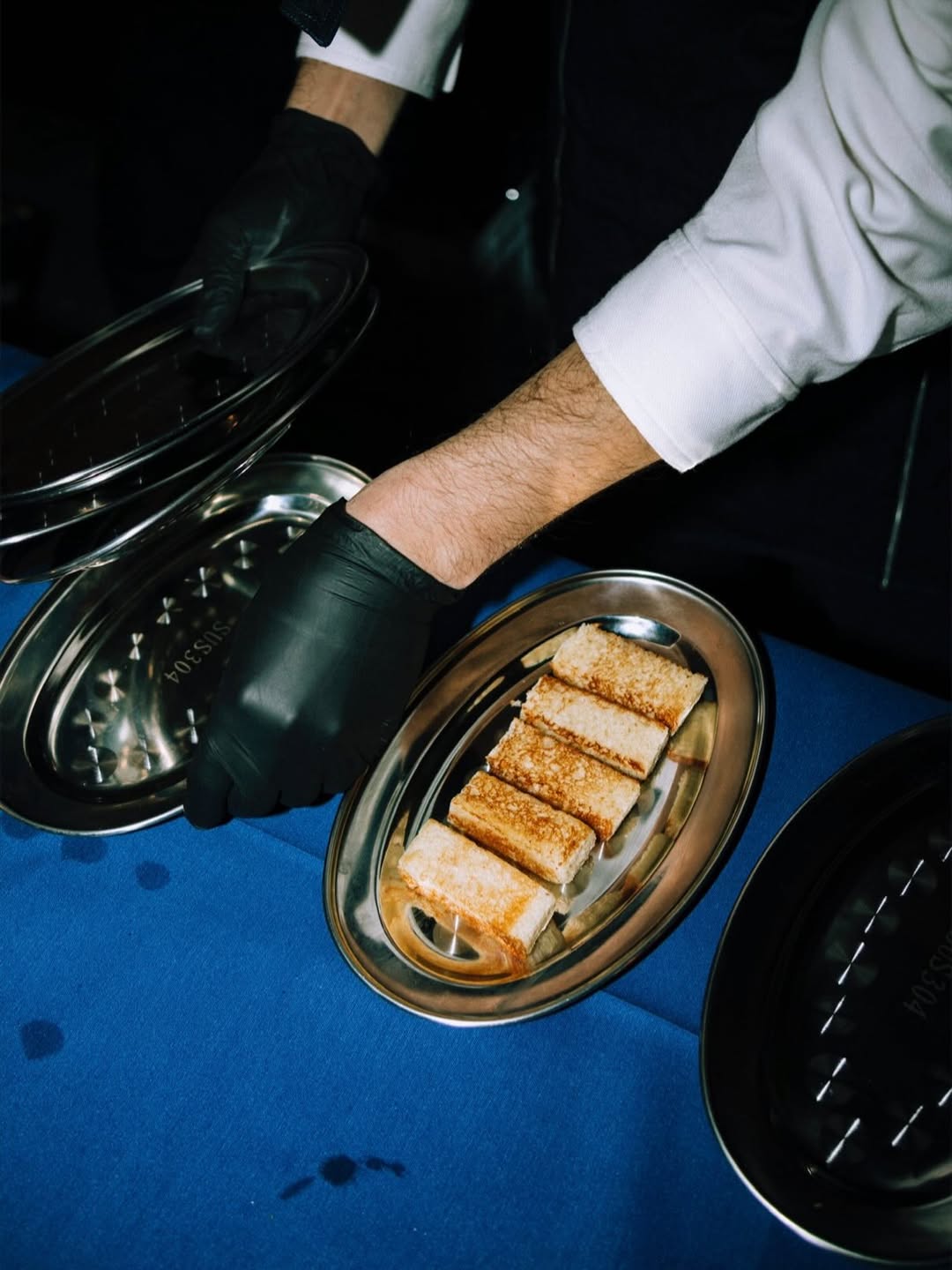 BENOW event dinner — chef serving toast on silver tray