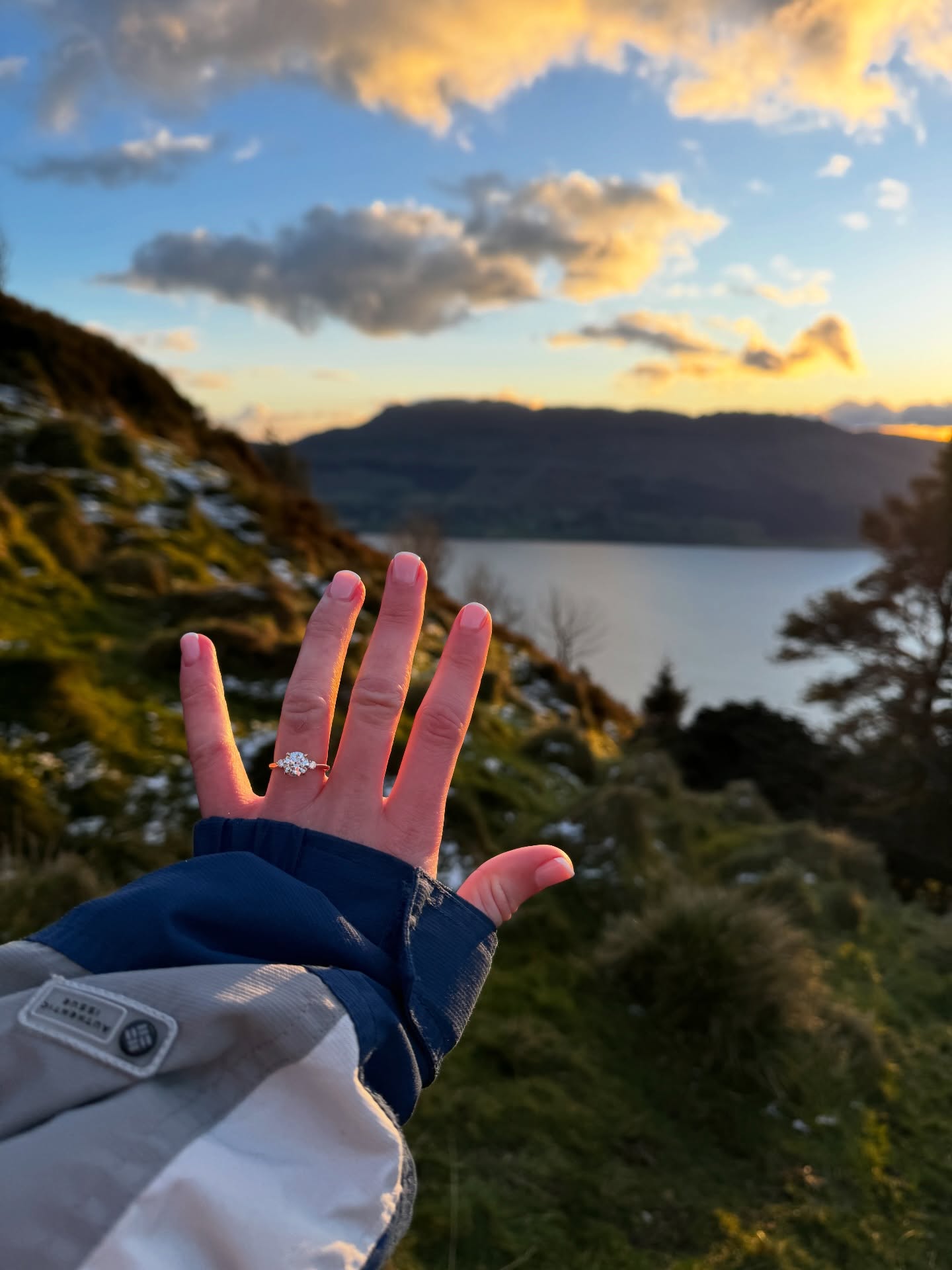 Engagement ring photo with scenic Irish lake and mountain backdrop