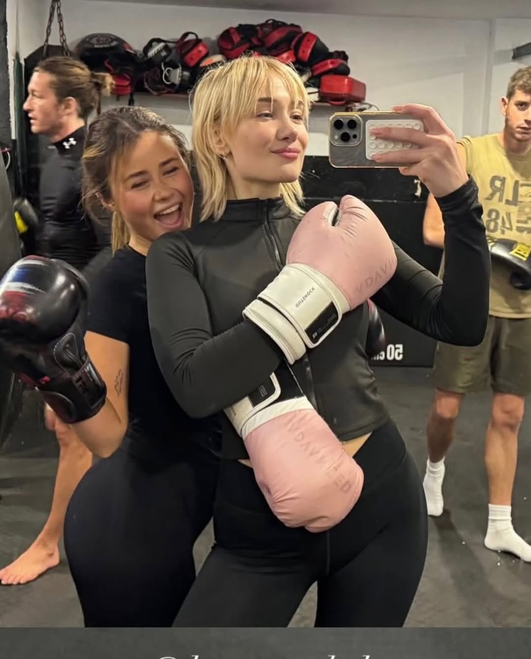 Two BENOW members laughing together after boxing class