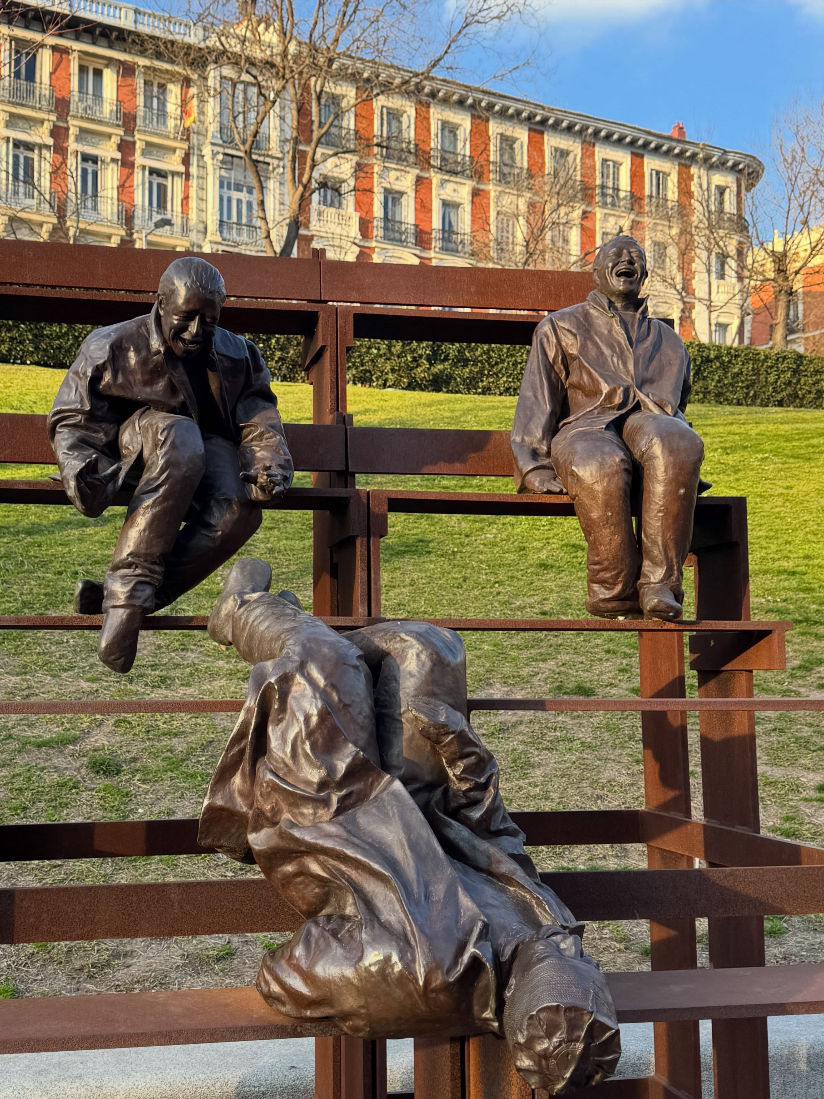 Bronze sculptures of laughing men in Spanish park