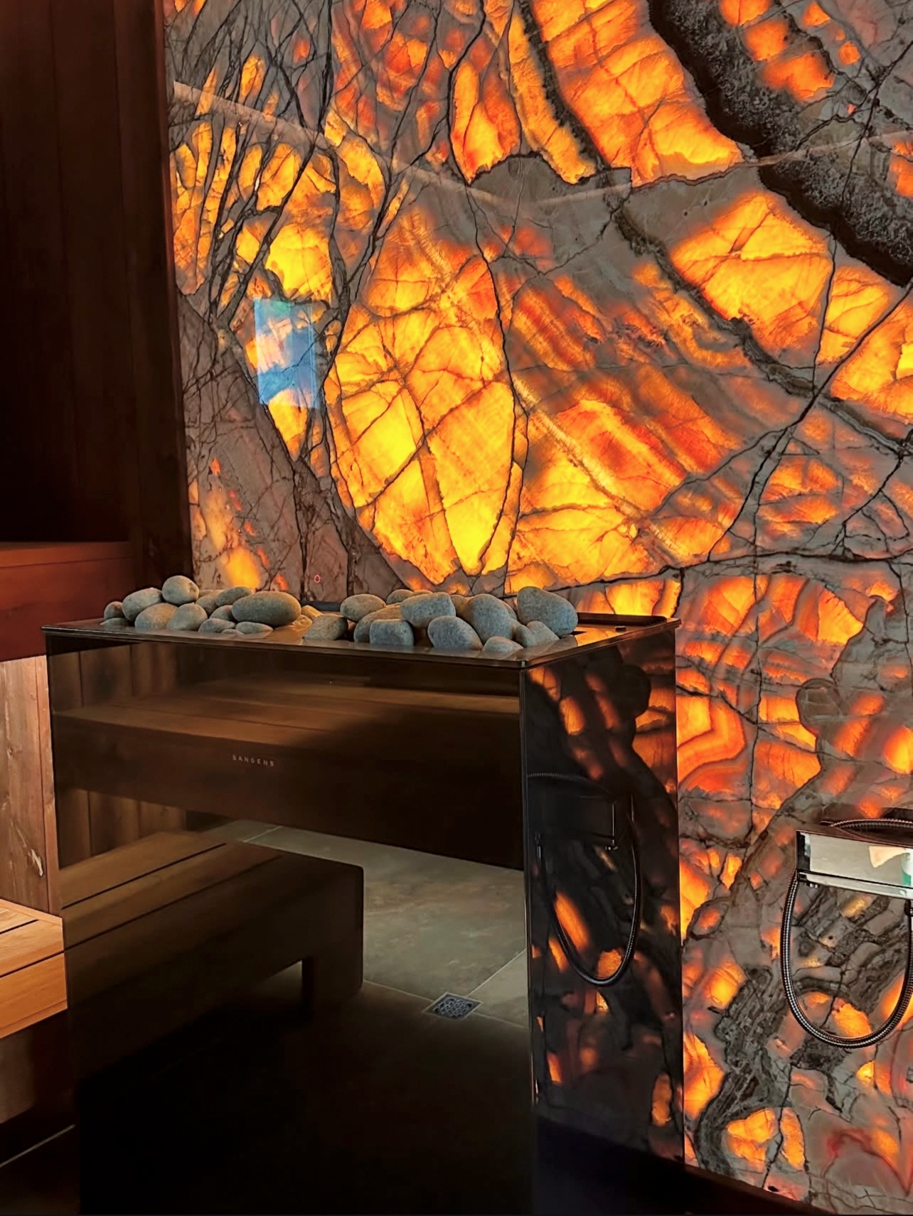 Wellness sauna showcase with dramatic backlighting, cedar construction, and sanctuary-like ambiance