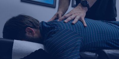Chiropractor performing spinal manipulation adjustment