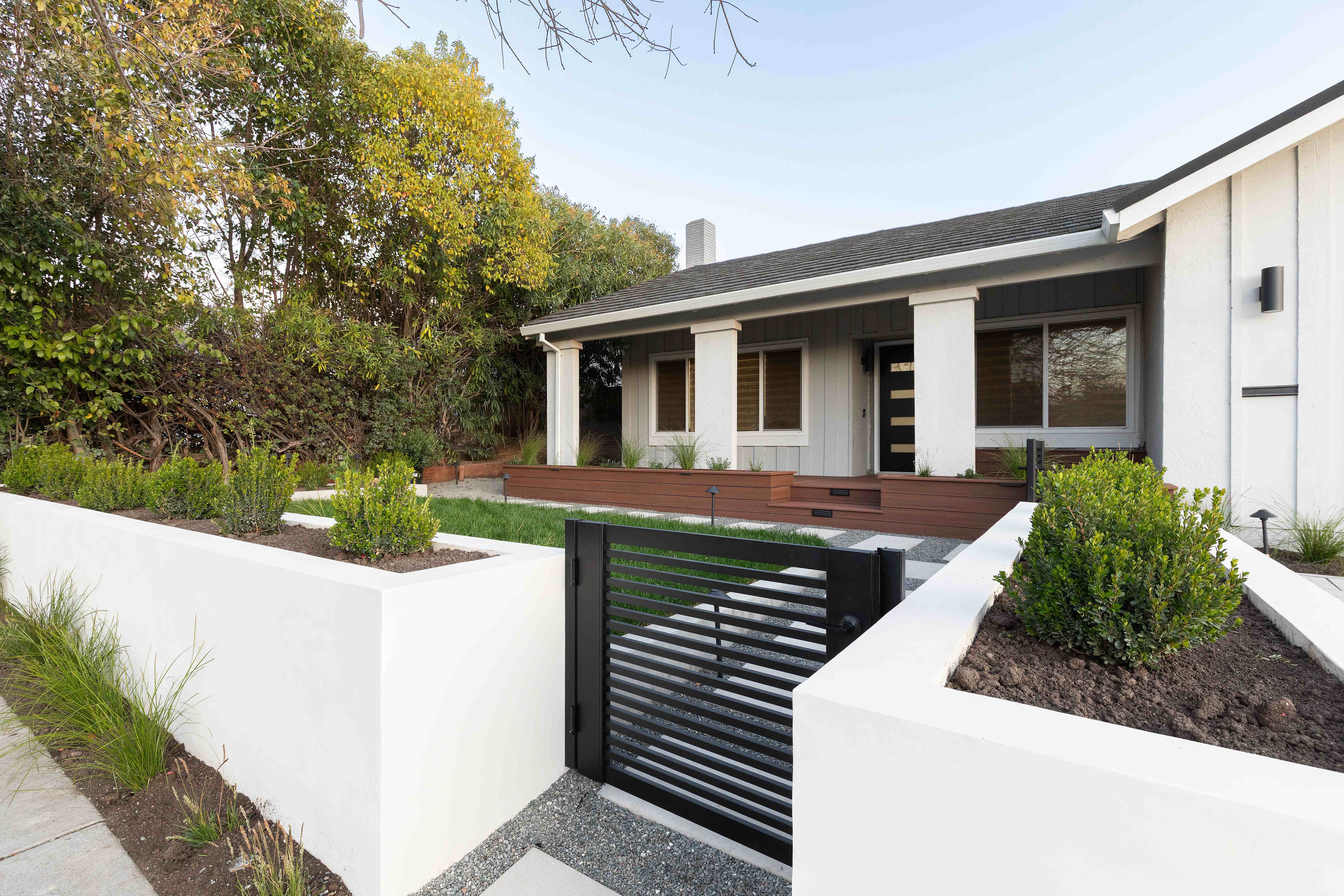 Modern front yard with white stucco retaining walls