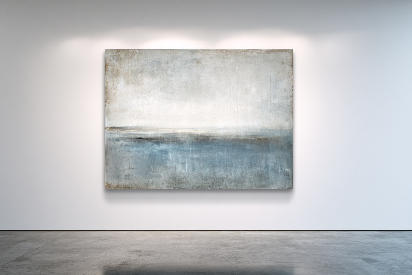 Atmospheric horizontal coastal with pale grey-cream sky and soft blue water