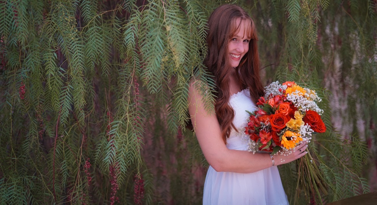 Taya with flowers and green foliage