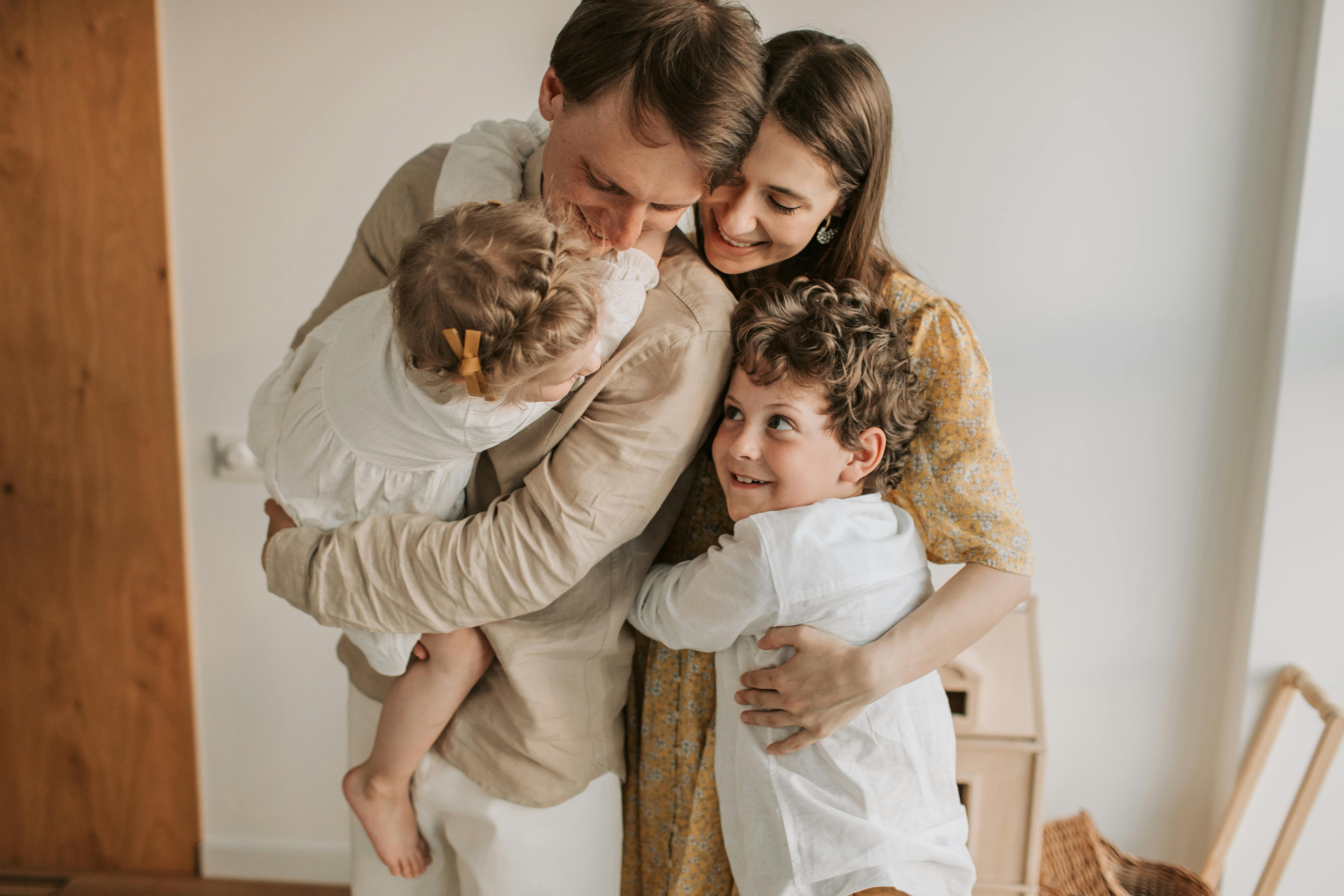 Happy family embracing in their newly renovated home