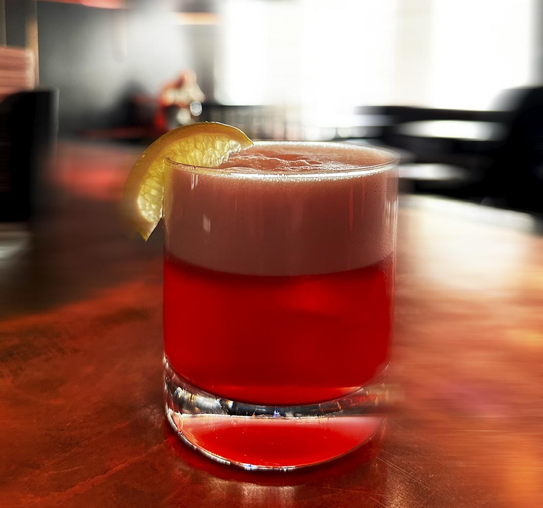Red cocktail with citrus