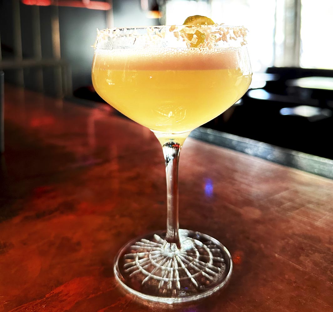 Yellow cocktail in coupe glass