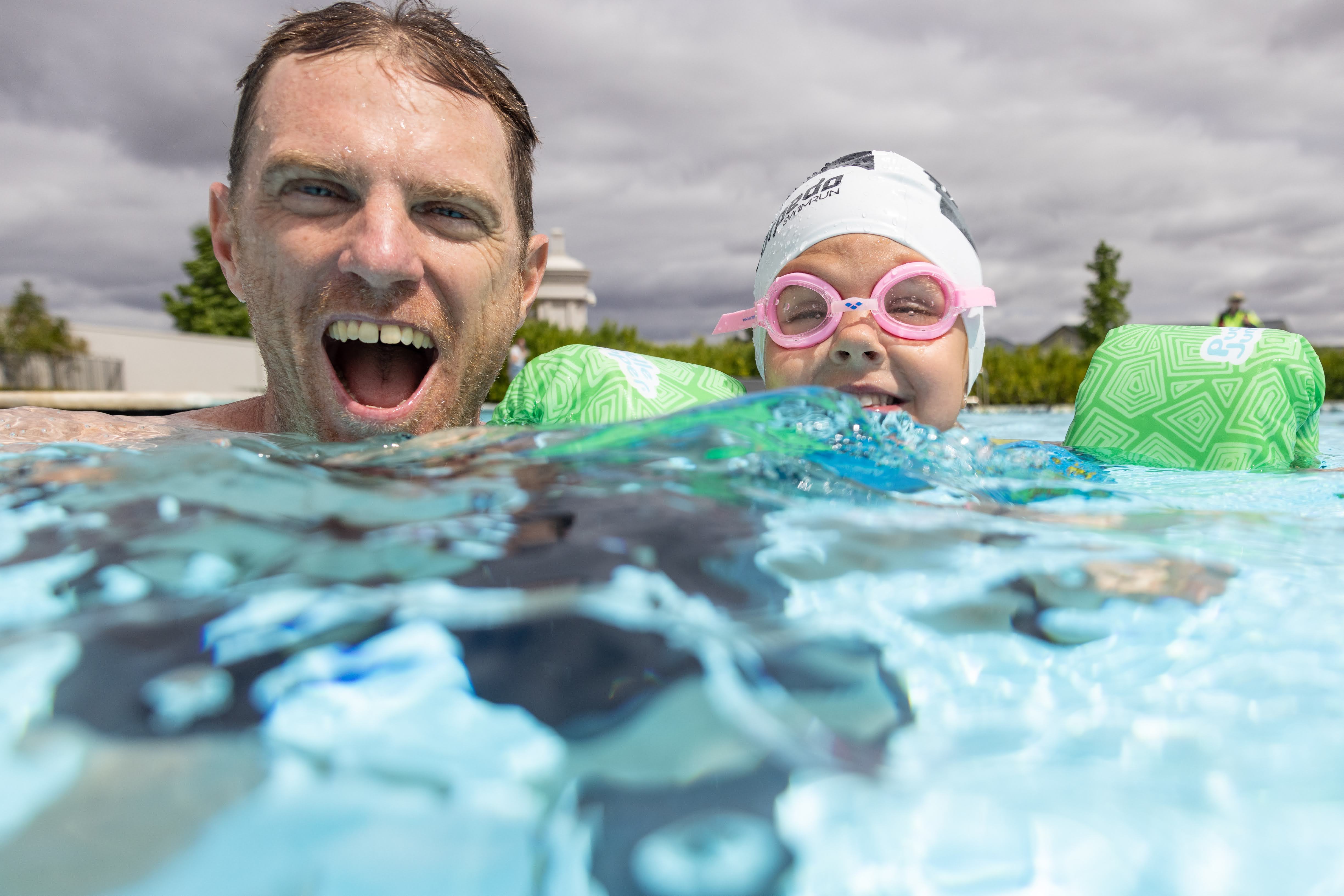 Parent and child swimming together