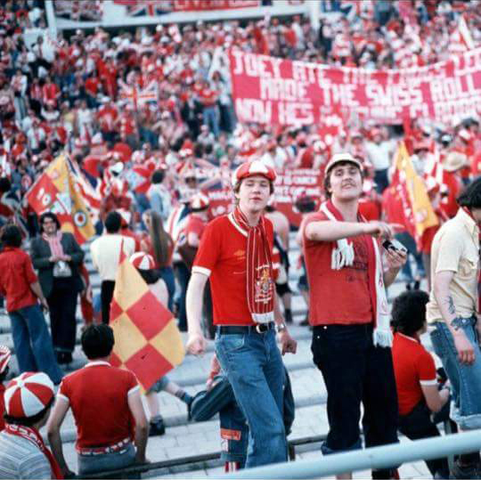 Fans in the stands with flags and banners