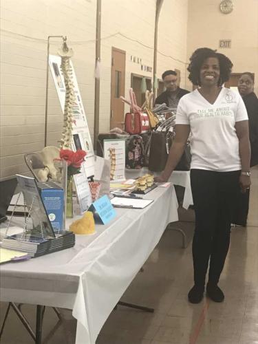 Dr. Mukaia at Women's Expo event booth