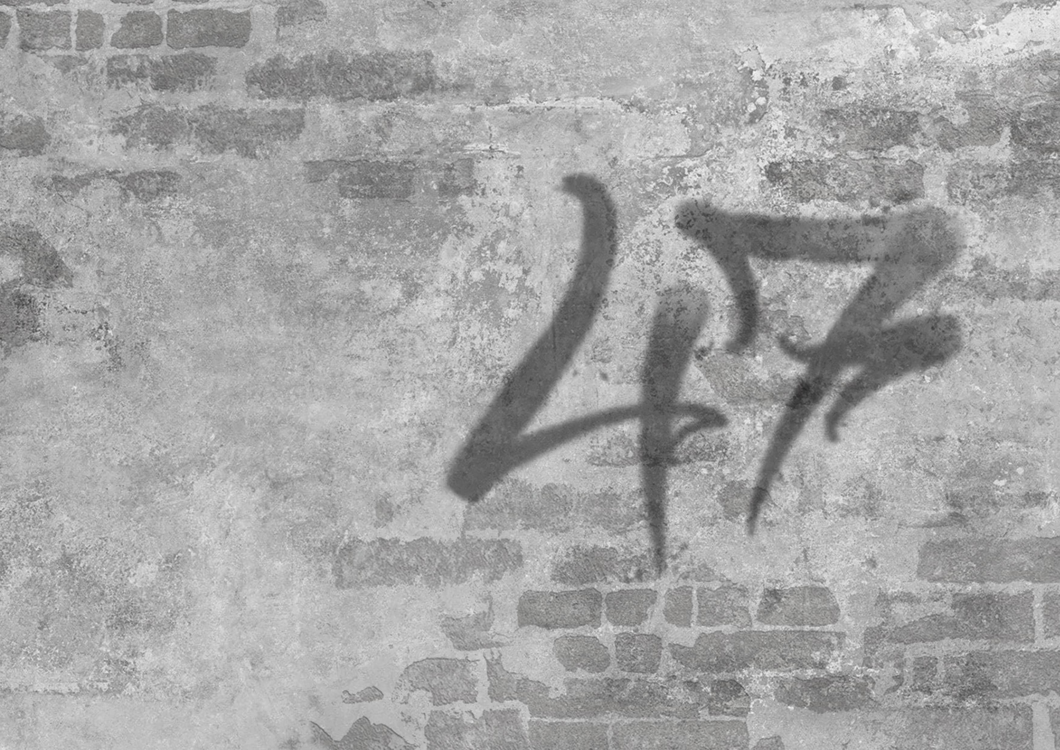 Betonwand mit Graffiti 47 – District Ink 47 Tattoo Studio