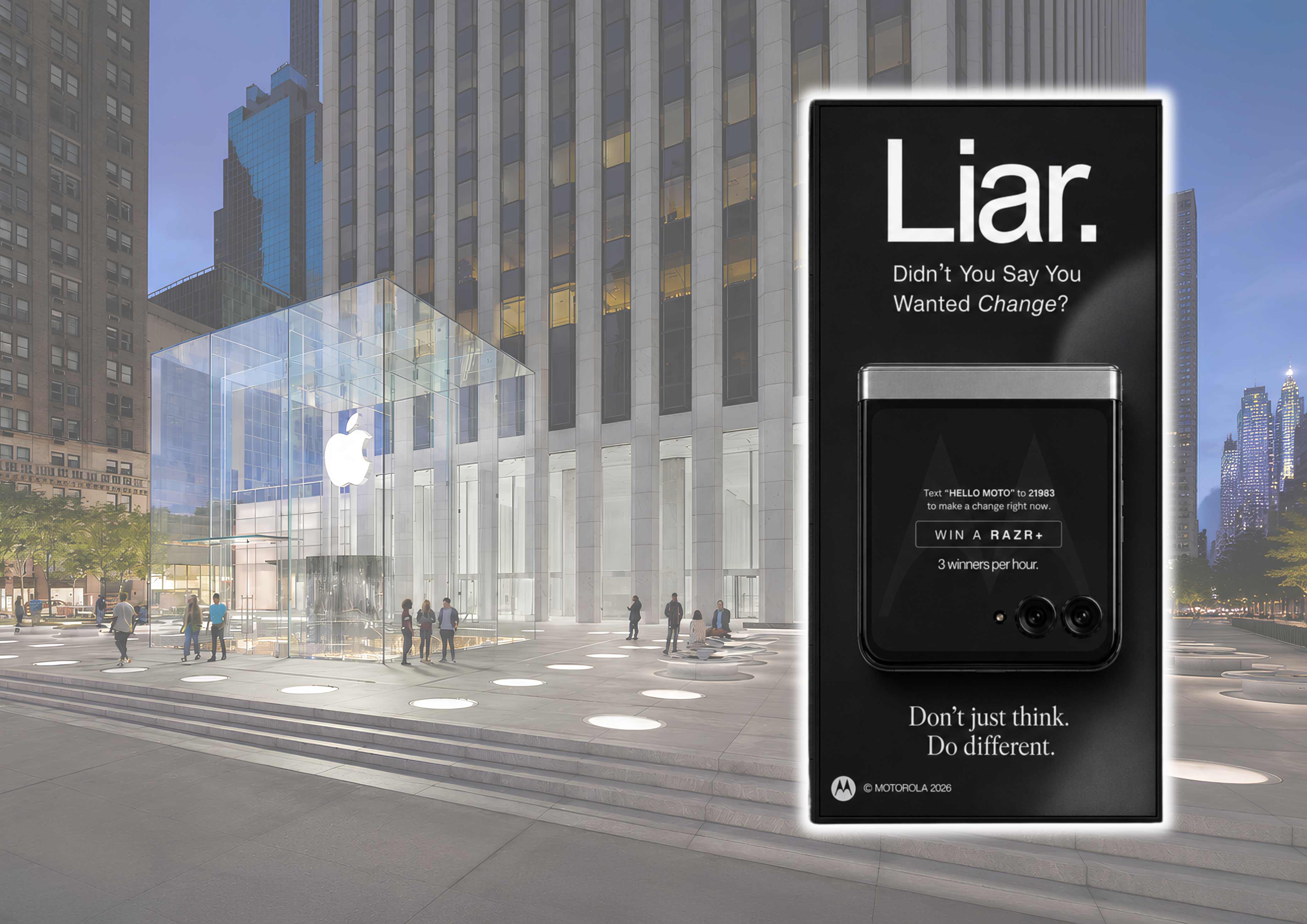 Motorola Liar billboard standing in the plaza beside Apple's glass-cube flagship store at dusk