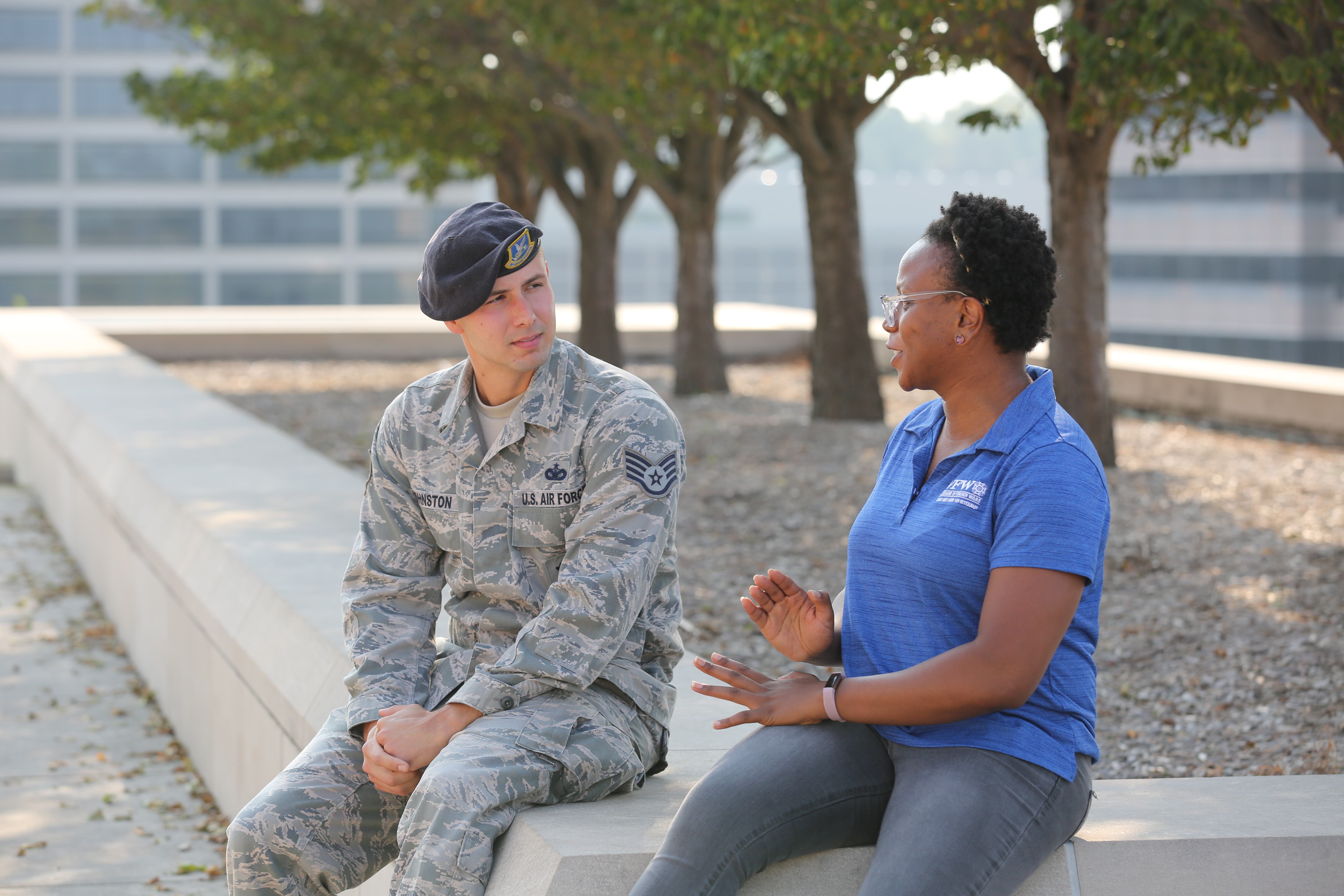 U.S. Air Force service member in conversation with VFW service officer outdoors