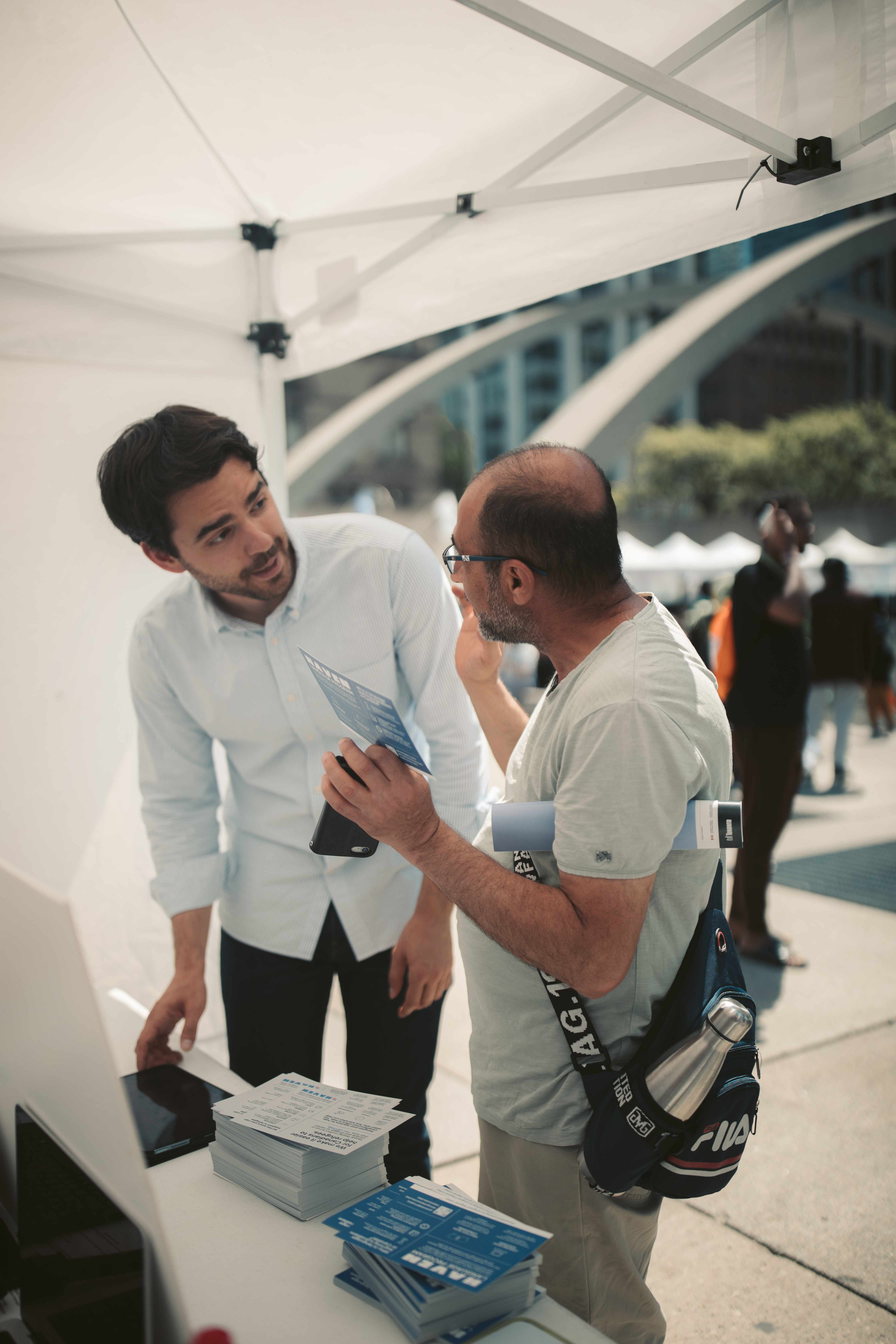 Victor Lal helping a newcomer at a Haven outreach event
