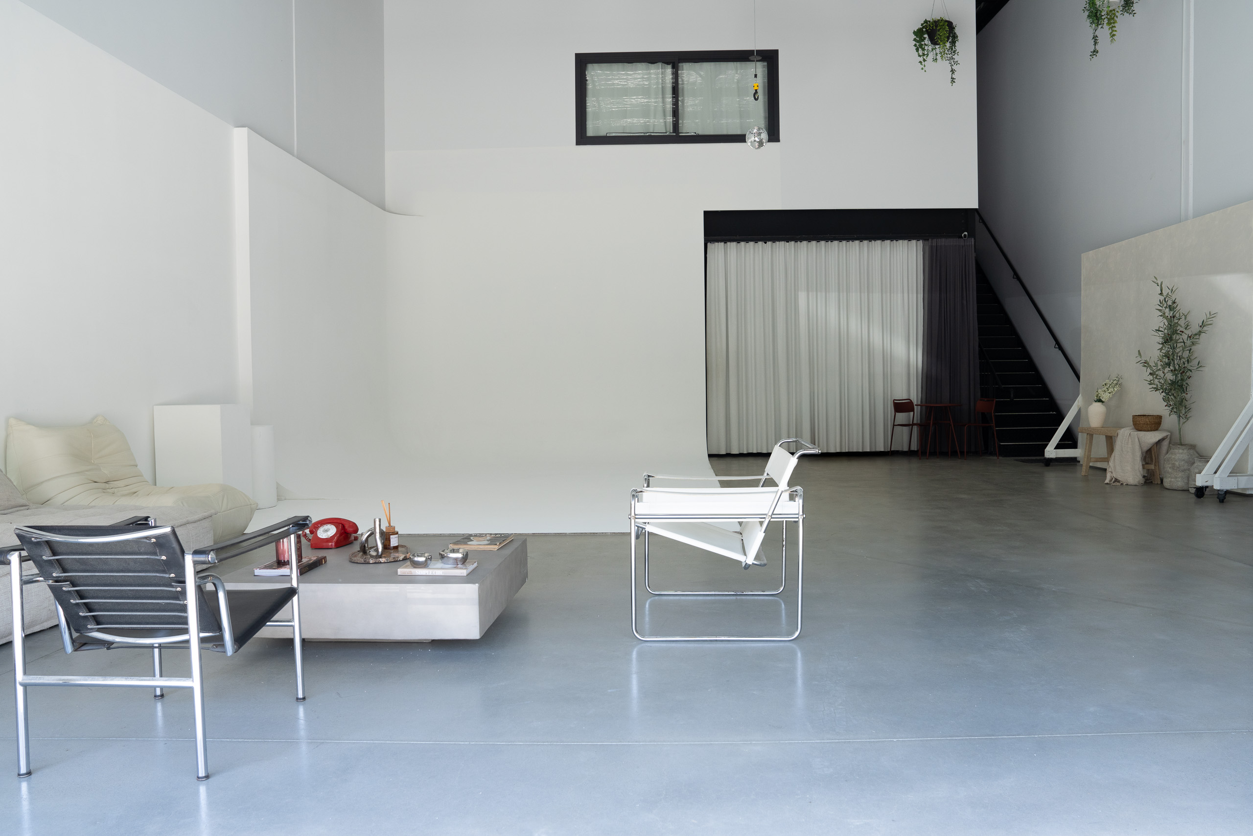 Wide studio view with cyclorama and seating area