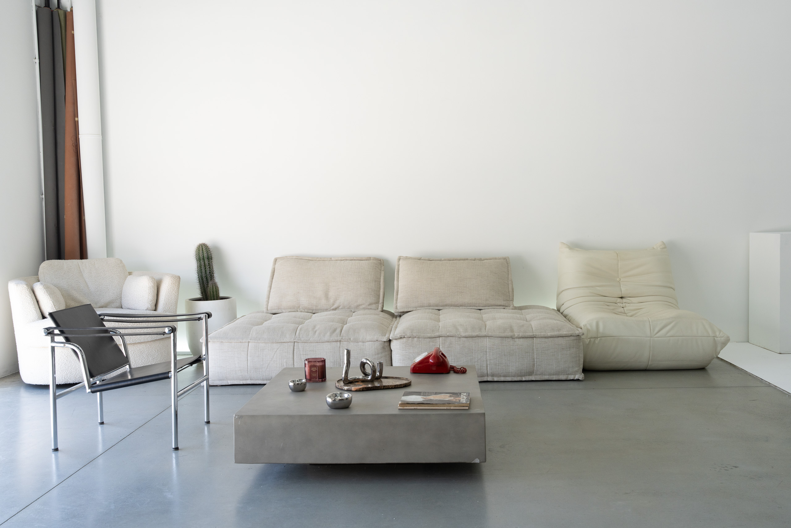 Lounge seating area with Togo sofa and styling props