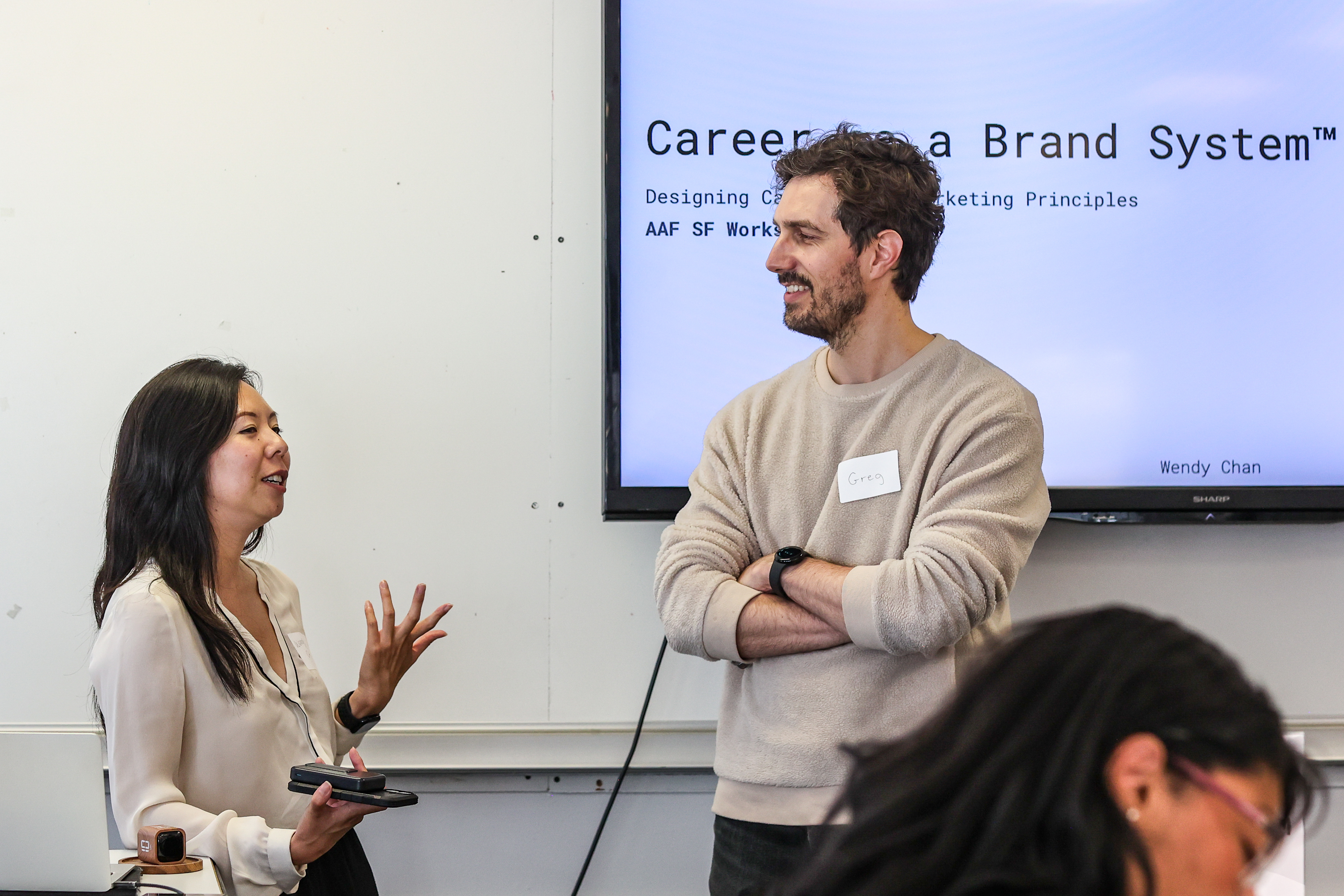 Wendy Chan in conversation with an attendee named Greg in front of the title slide