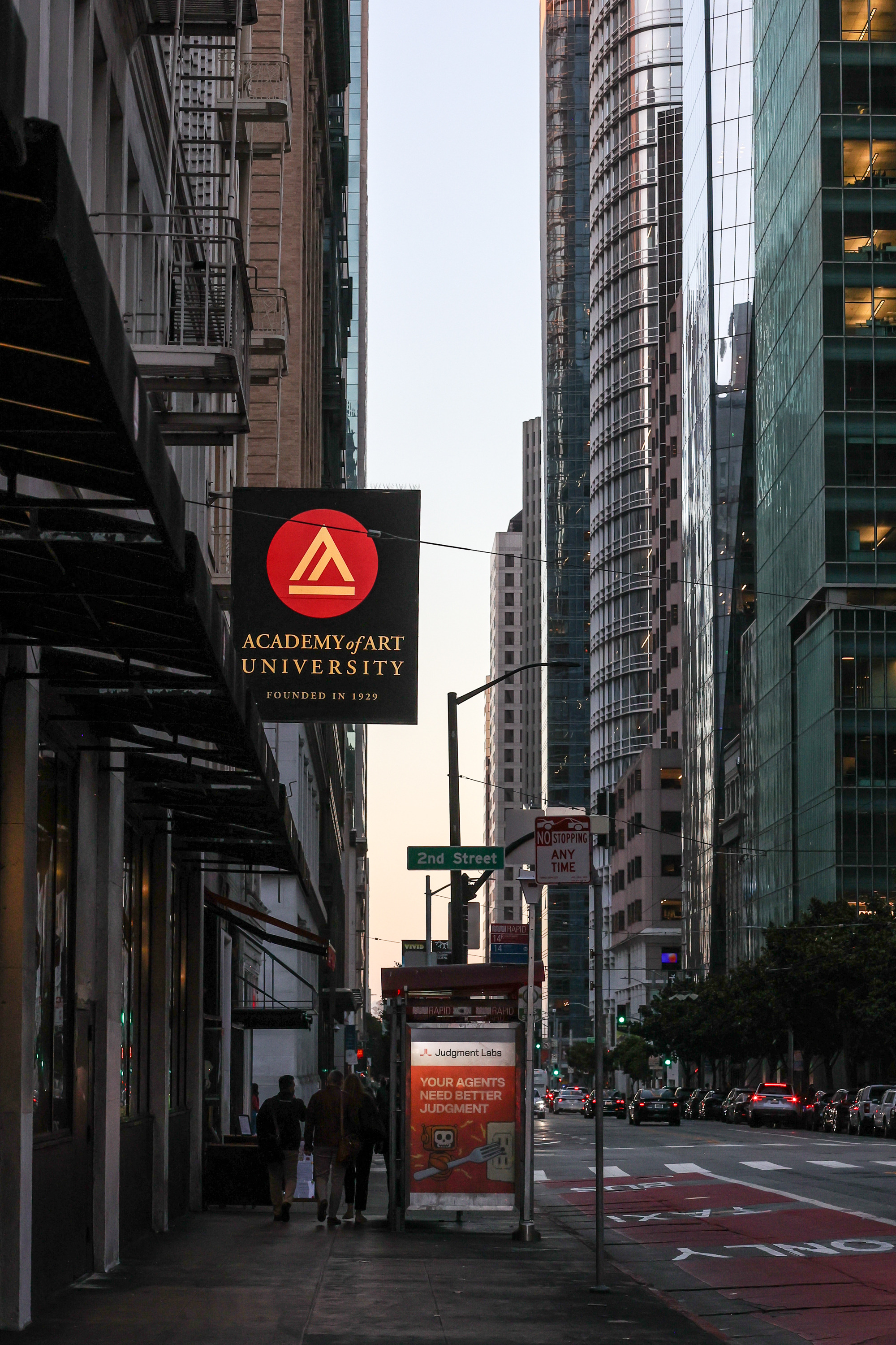 Academy of Art University street sign on a downtown San Francisco block at dusk