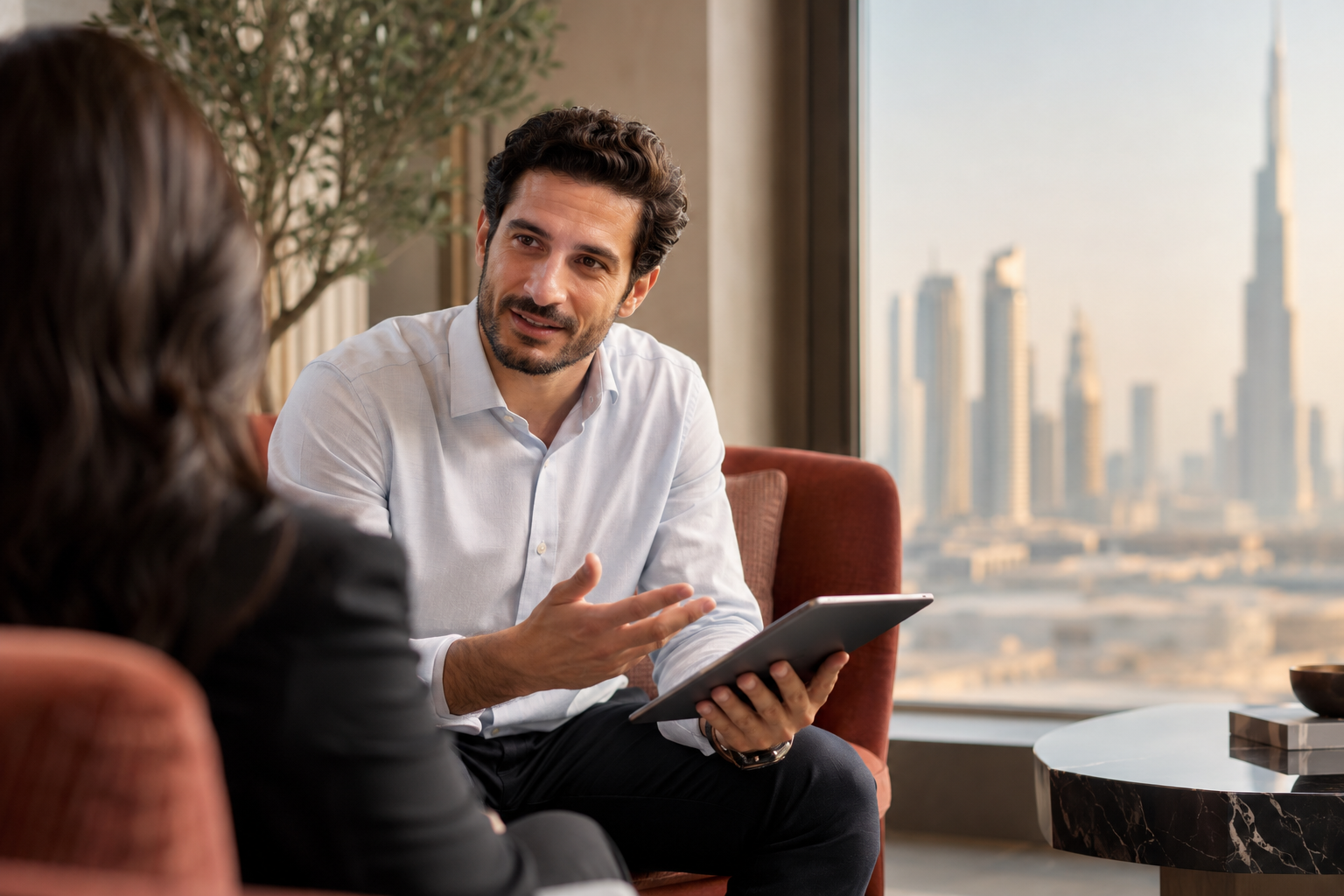 Senior consultant speaking with a client in a Dubai office
