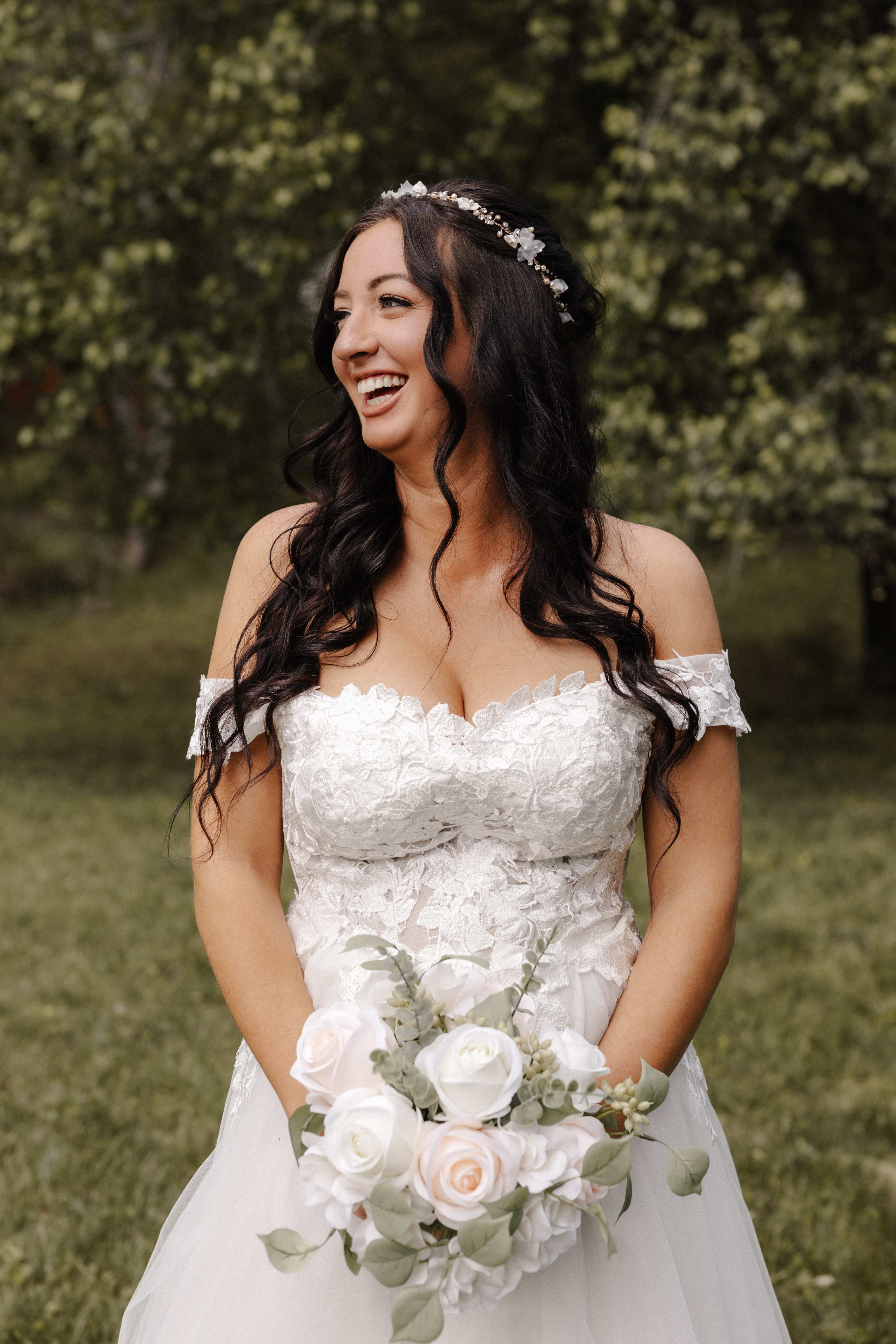 Laughing bride portrait with white and blush bouquet